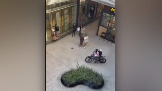 Dirt bike riders roll around Century City mall