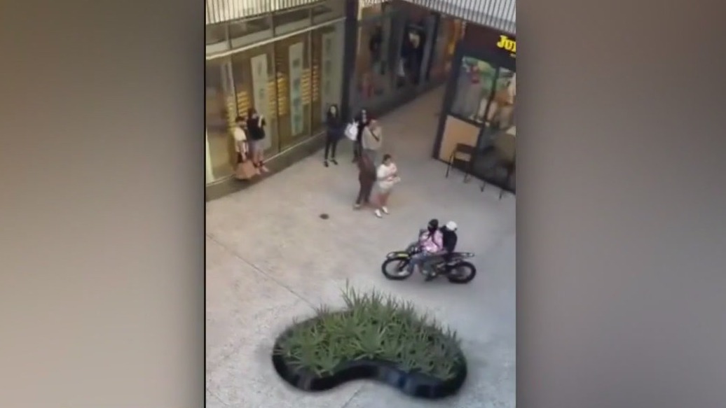 Dirt bike riders roll around Century City mall