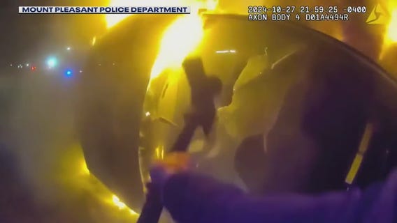 Police bodycam captures heroic rescue from burning car