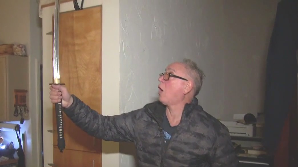 Man grabs sword to ward off looters