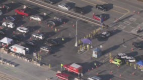 Evacuees wait several hours in line to return home