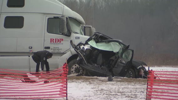 Vehicle sandwiched between semi-trucks in Macomb County