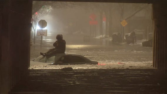 Detroit firefighters rescue driver from roof of car