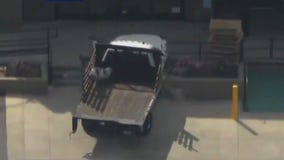 Truck hits several cars, building in police chase