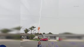Lightning strike behind little girl