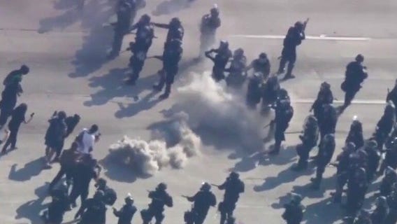 Law enforcement, protesters kick smoke can