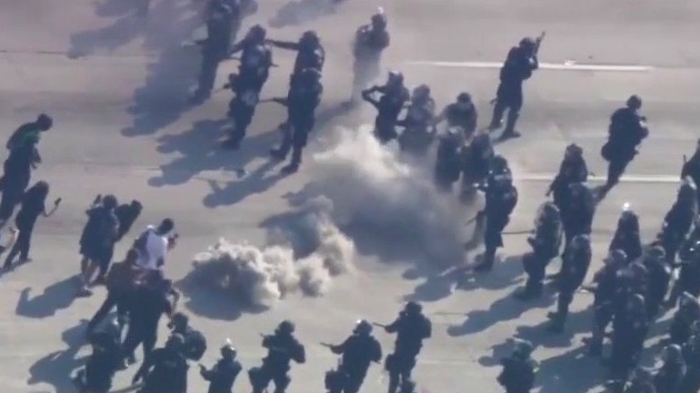 Law enforcement, protesters kick smoke can