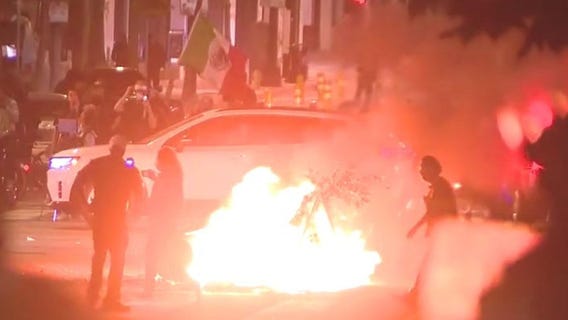 Fireworks go off, bonfire set in front of cops