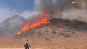 Fire rages amid triple-digit temps