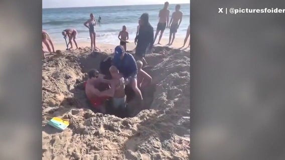 2 kids get trapped in collapsed sand hole