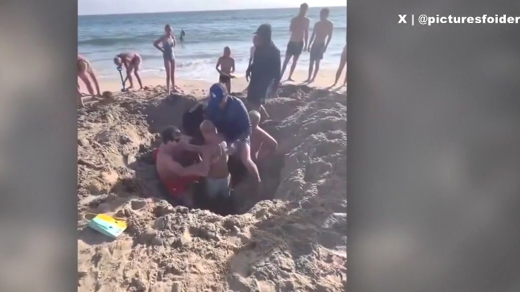 2 kids get trapped in collapsed sand hole