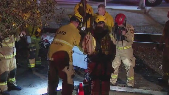 LA firefighters rescue woman from manhole