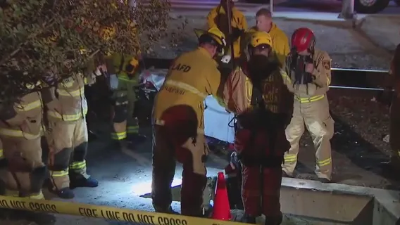 Firefighters rescue woman from manhole