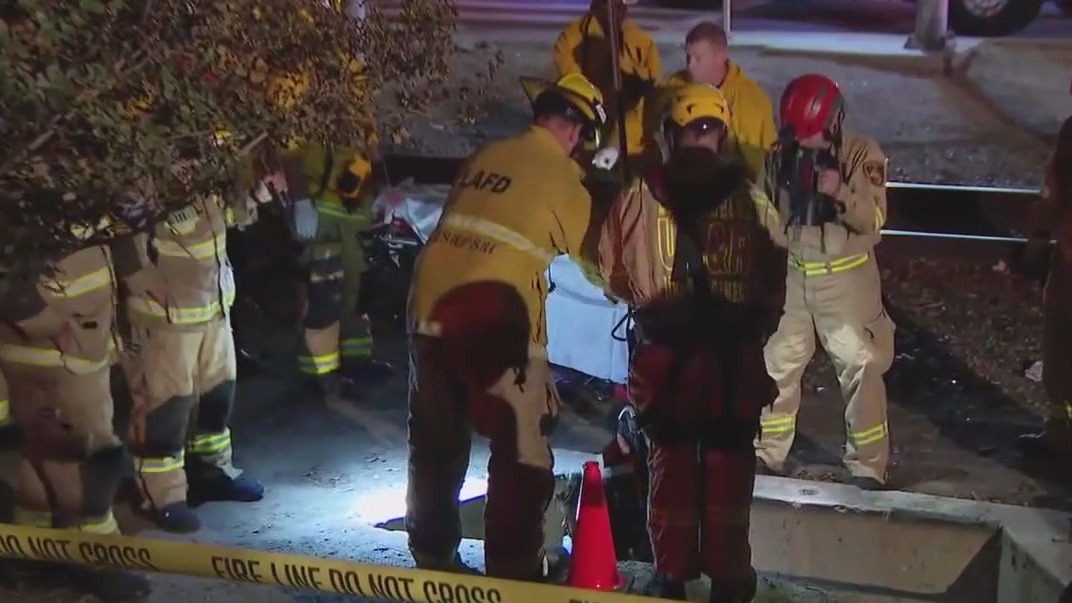Firefighters rescue woman from manhole