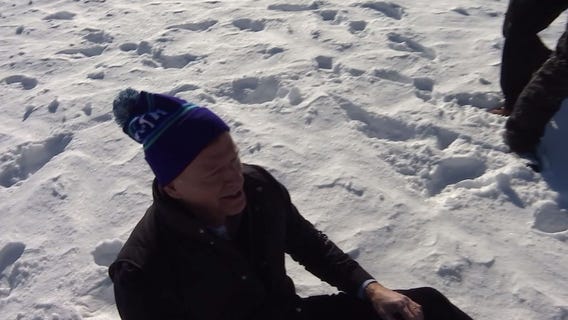 Fox 9 photographer helps Roger Goodell up after fall at Super Bowl event