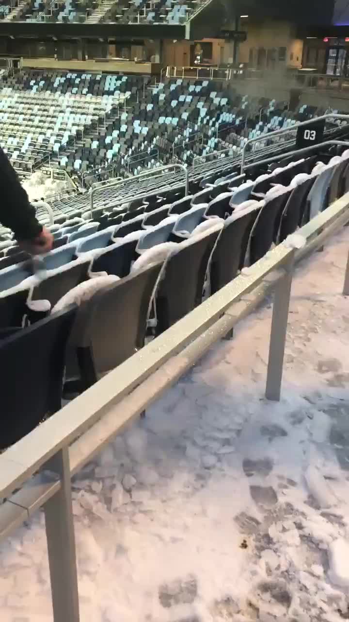 Grounds crew chipping ice from seats at Allianz Field