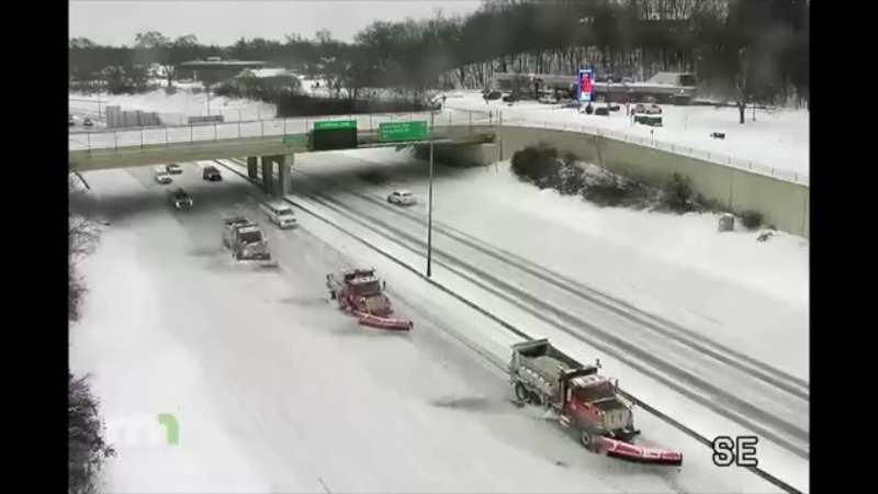 Triple snowplows clearing highway