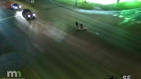 Truck drops beer on roadway, drivers stop to retrieve it in the street