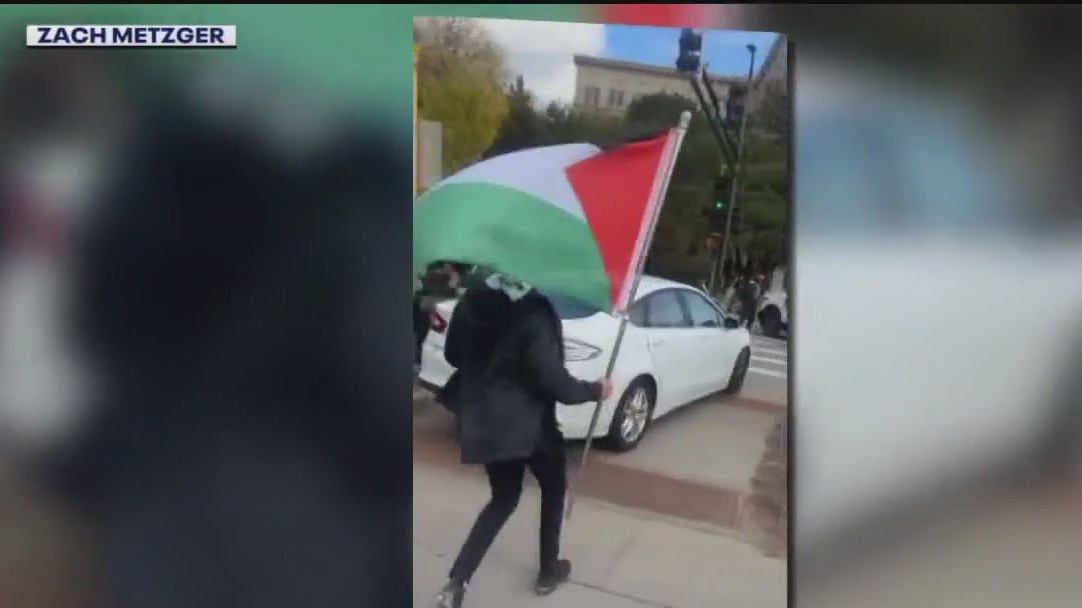 Confrontation between protesters, driver at rally