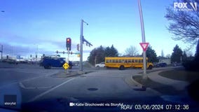 Truck runs red light, crashes into school bus full of children
