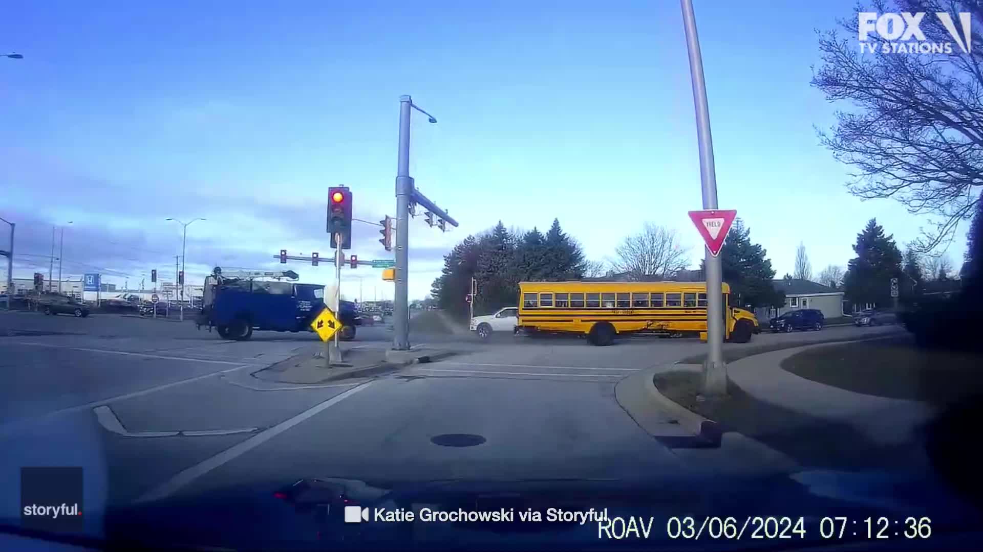 Truck runs red light, crashes into school bus full of children