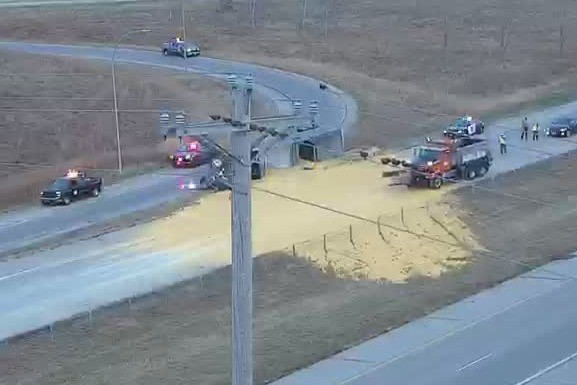 Truck tips over, spills corn all over highway