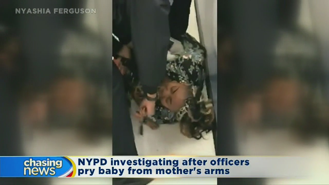 NYPD officers pry baby from mom's arms