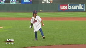 Girl with robotic hand throws pitch at Target Field