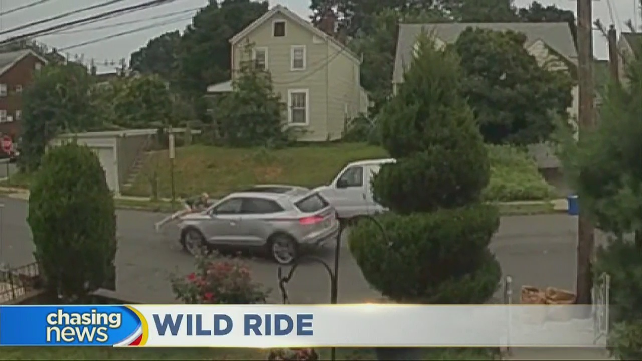 Man hangs onto hood of stolen car