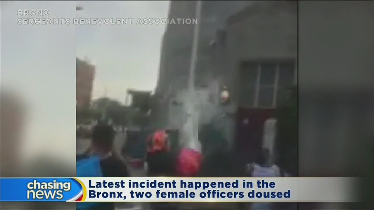 New videos emerge showing people dousing cops with water