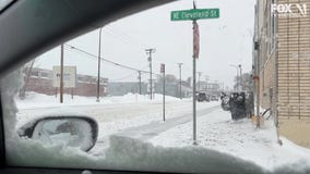 Person skis down street after MN snowstorm