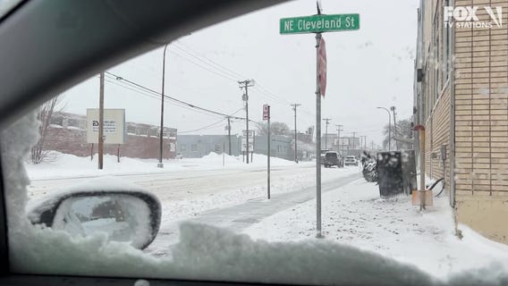 Person skis down street after MN snowstorm