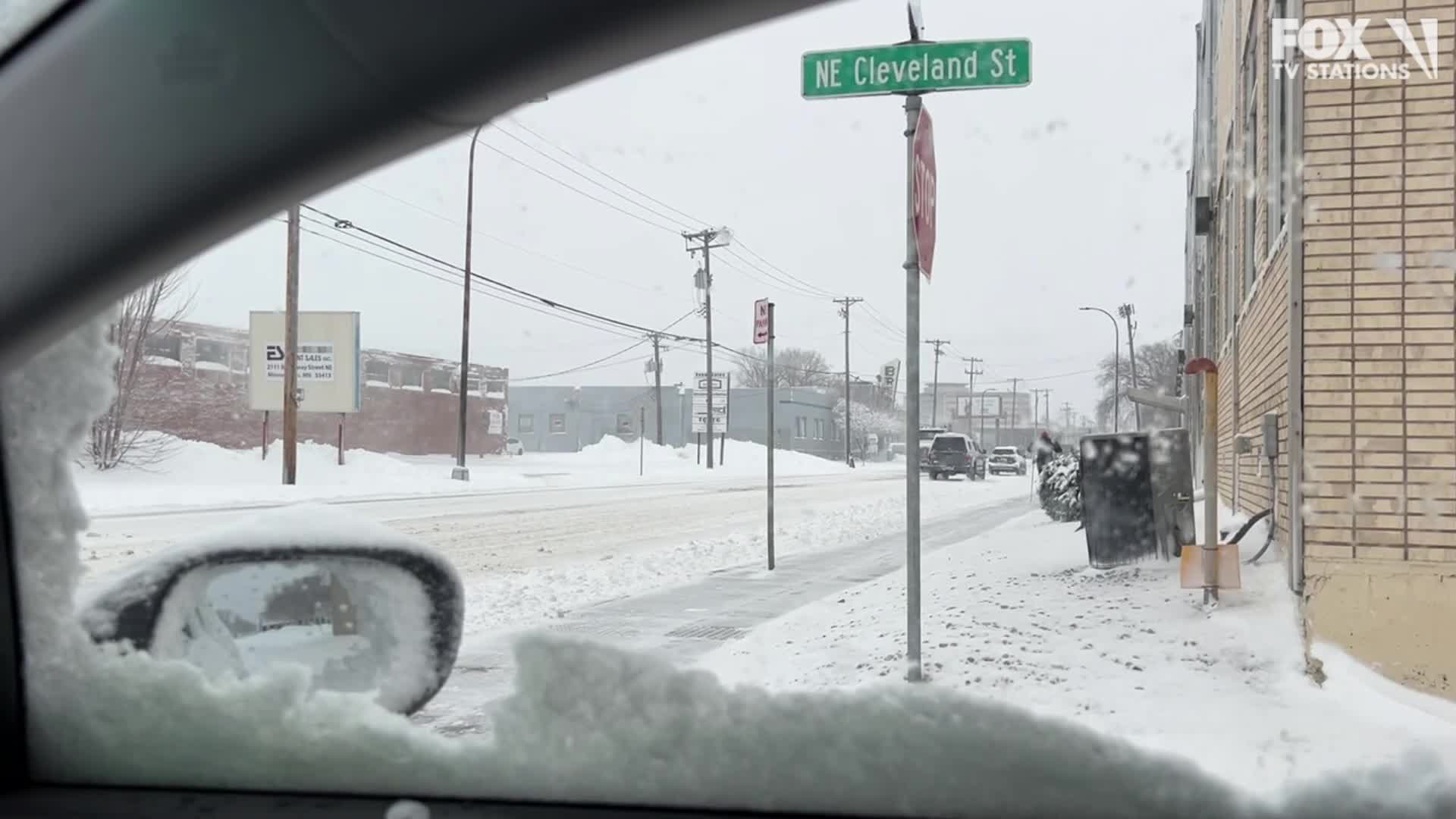 Person skis down street after MN snowstorm