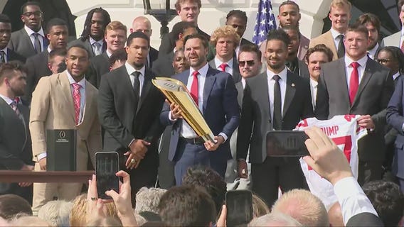 J.D. Vance fumbles College Football Playoff trophy