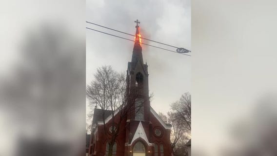 WATCH: Steeple on fire after being struck by lighting