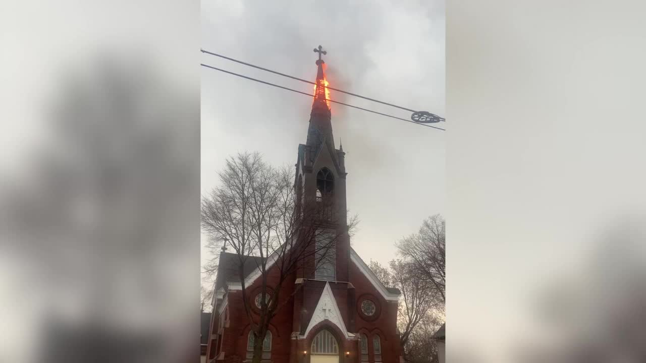 WATCH: Steeple on fire after being struck by lighting
