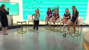 MN Aurora shows soccer tips to young fan