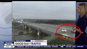 Car slides on icy road and narrowly avoids stopped vehicle