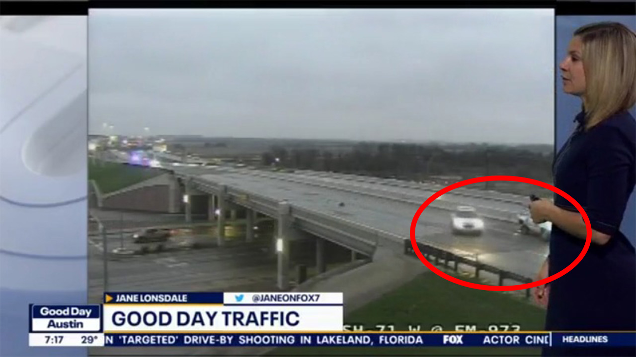 Car slides on icy road and narrowly avoids stopped vehicle