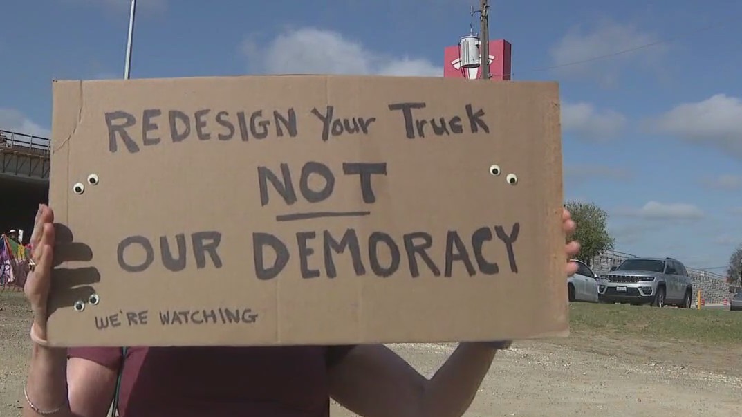 Protesters gather outside Austin Tesla dealership