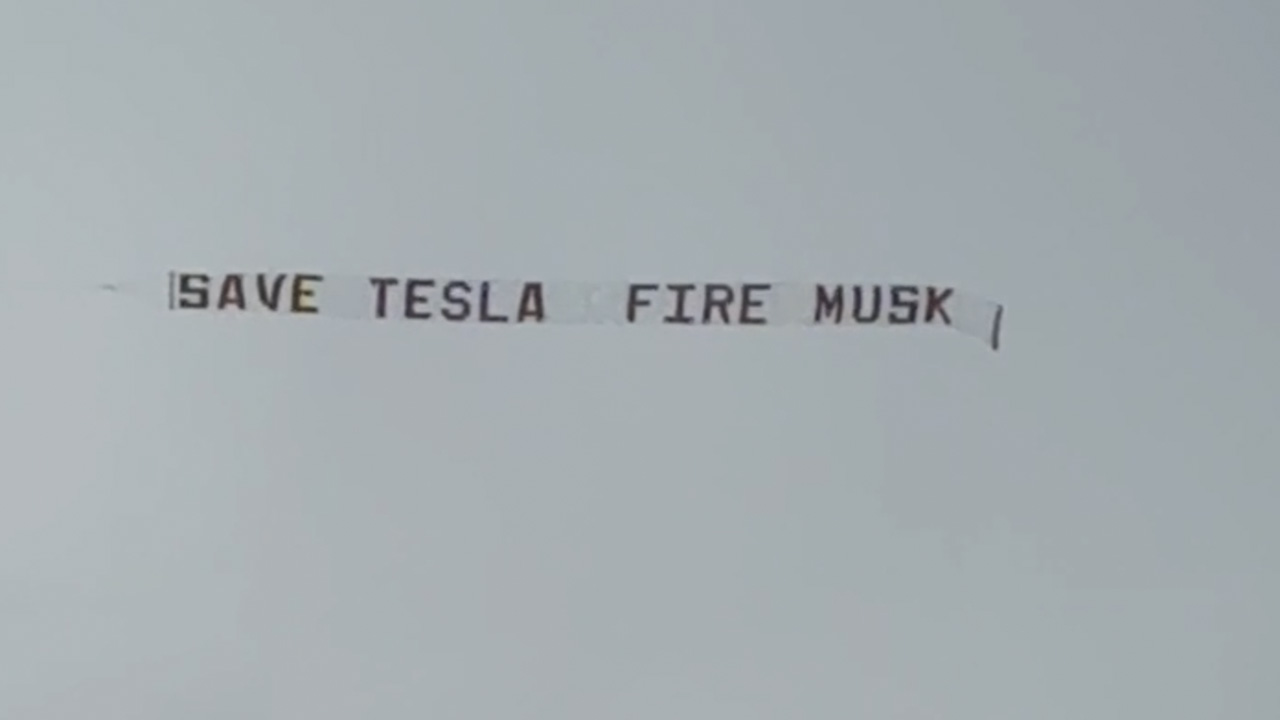 'Save Tesla Fire Musk' banner over downtown Austin