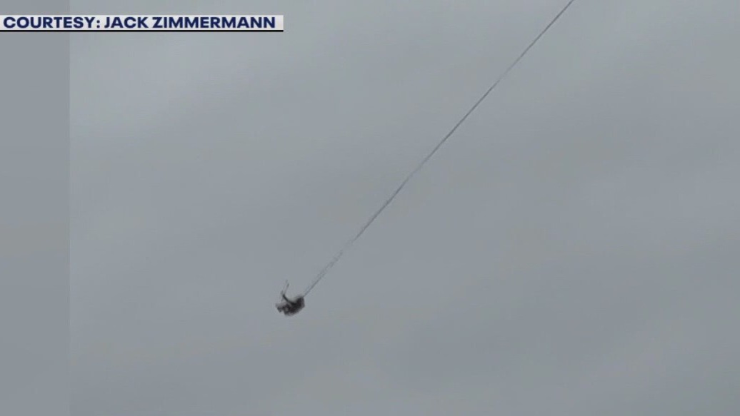 Man seen swinging from downtown Austin crane