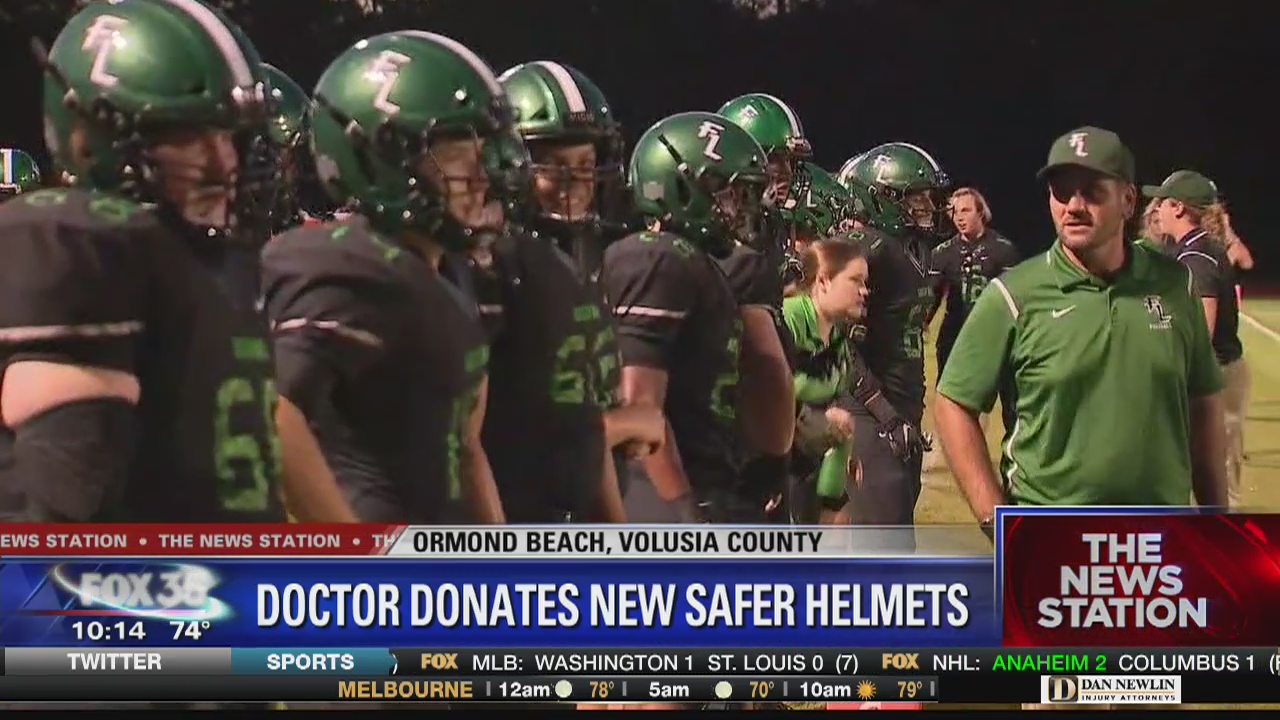 Doctor honored at football game for generous donation to purchase helmets