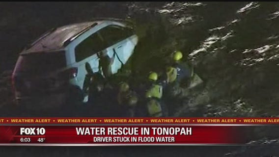 Firefighters rescue man trapped in flooded minivan