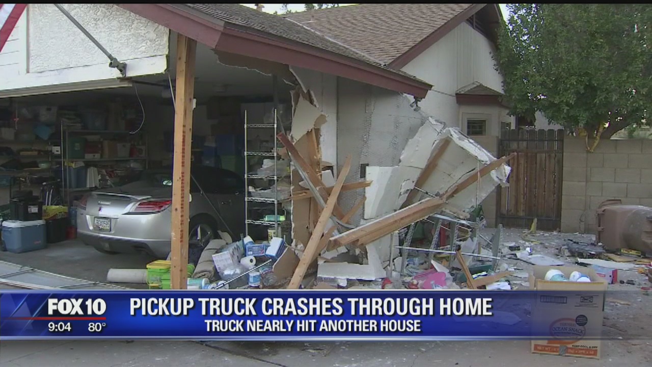 Pickup truck crashes through home