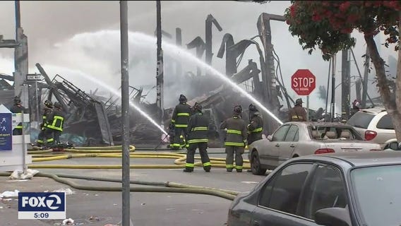 San Francisco firefighters continue dousing hot spots from Tuesday's massive inferno; investigation ongoing