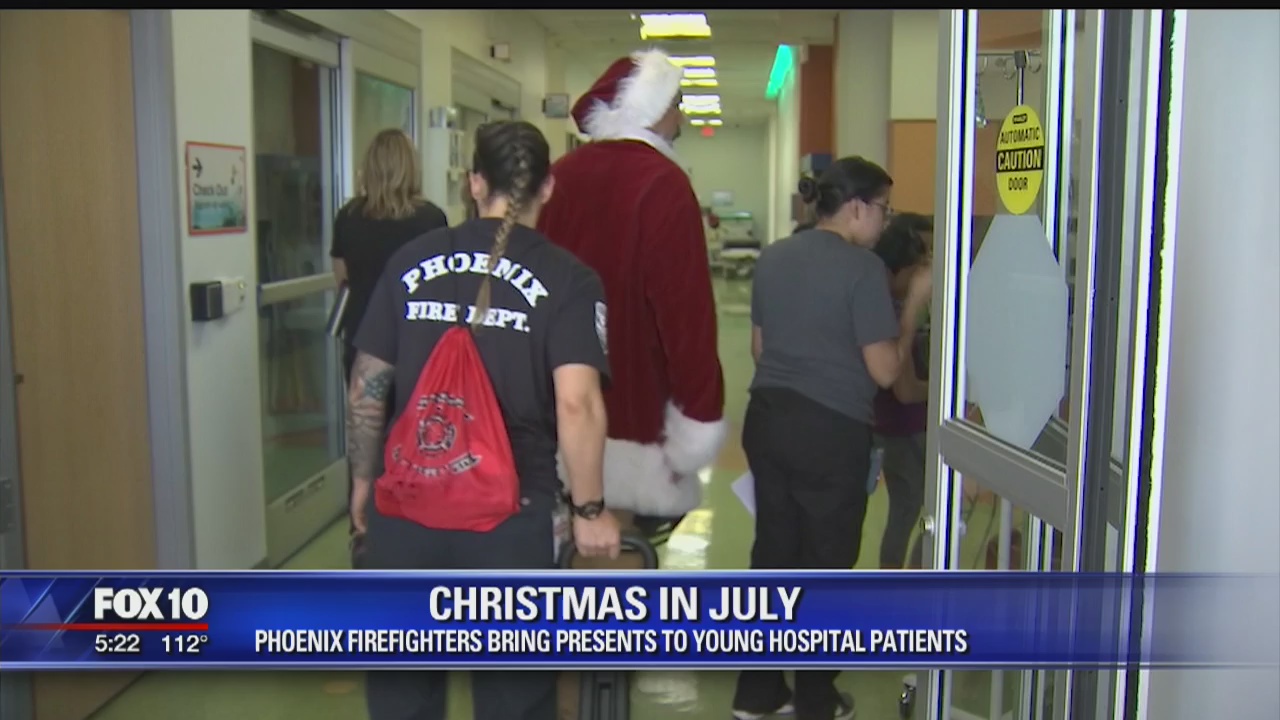 Firefighters bring presents to young patients in "Christmas in July" event