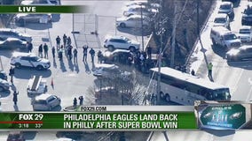 Late Eagles fan's challenge coin held during SBLII
