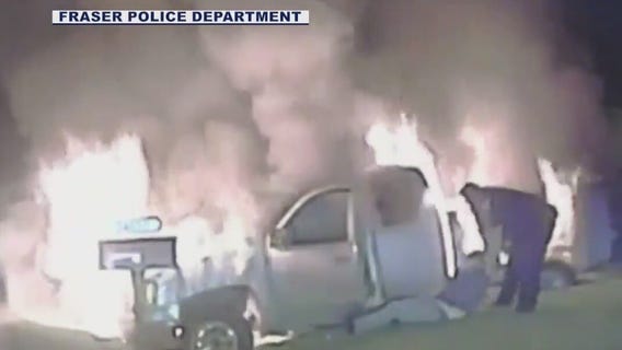 Officer pulls woman from burning truck