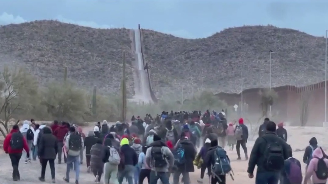 Migrants enter Arizona through border wall breach
